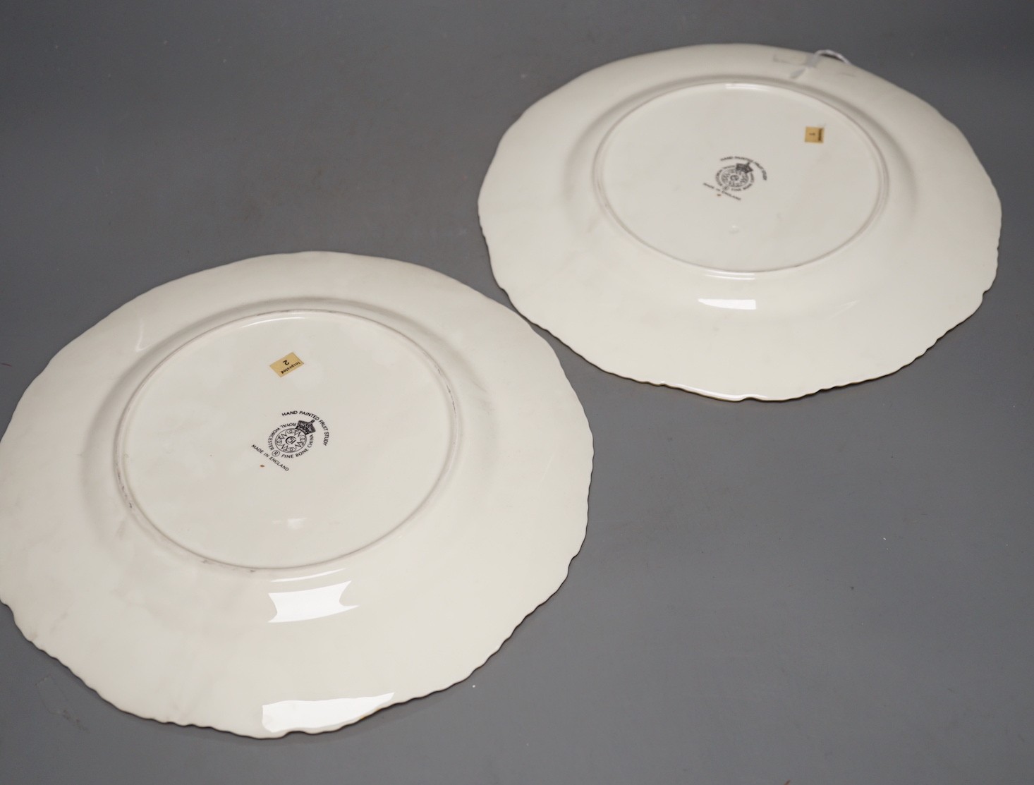 A pair of Royal Worcester fruit painted dinner plates, post war, by J. Reed, 27cm diameter